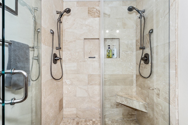 bathroom featuring a shower with door