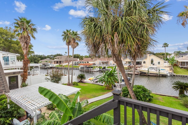 dock area featuring a water view and a lawn