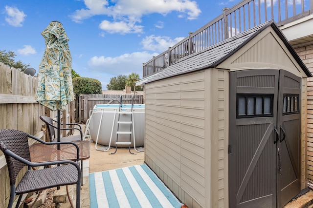 view of outdoor structure featuring a fenced in pool