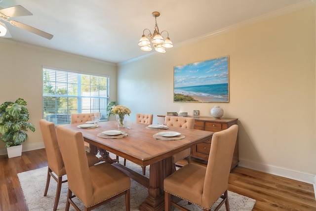 dining area featuring ceiling fan with notable chandelier, ornamental molding, and dark hardwood / wood-style floors