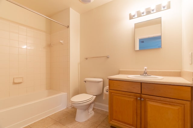 full bathroom with toilet, tiled shower / bath, vanity, and tile patterned flooring