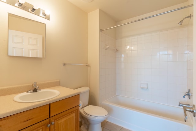 full bathroom with vanity, tiled shower / bath combo, toilet, and tile patterned flooring