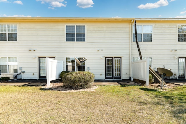 back of property with a lawn