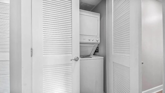 laundry area featuring stacked washer and clothes dryer