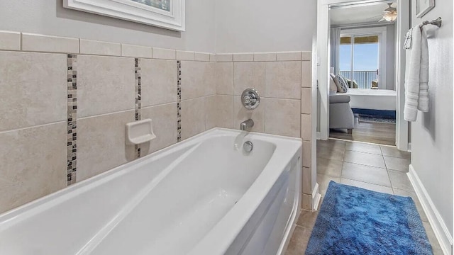 bathroom featuring tile patterned floors, a bathtub, and ceiling fan