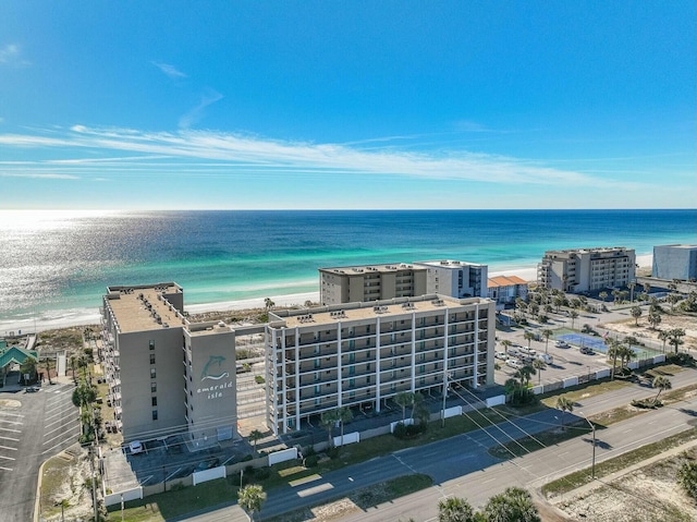 birds eye view of property featuring a water view and a beach view