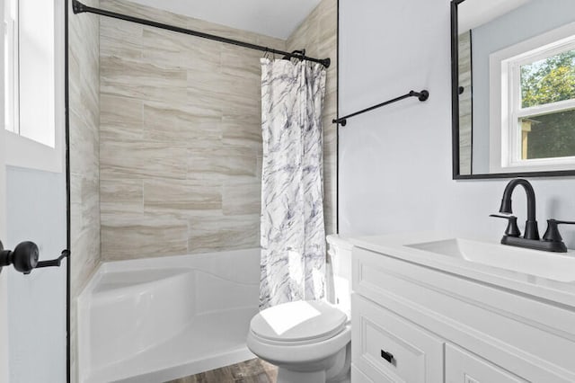 bathroom featuring toilet, vanity, and hardwood / wood-style floors