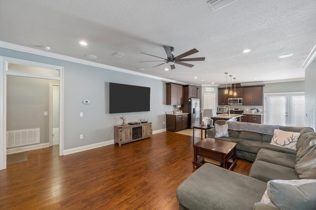 2137 Janet St, Navarre, FL 32566 - living area with crown molding, dark wood-style flooring, a ceiling fan, a textured ceiling, and recessed lighting