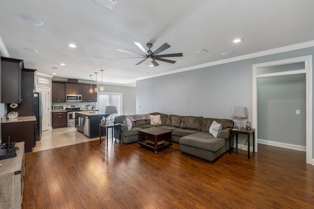 2137 Janet St, Navarre, FL 32566 - living room with crown molding, a ceiling fan, wood finished floors, recessed lighting, and baseboards