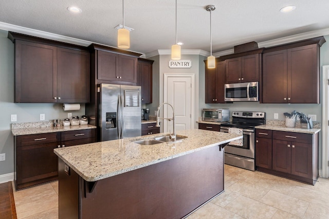 2137 Janet St, Navarre, FL 32566 - kitchen with stainless steel appliances, a sink, dark brown cabinetry, crown molding, and pendant lighting