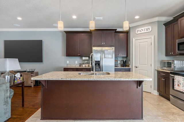 2137 Janet St, Navarre, FL 32566 - kitchen featuring stainless steel appliances, crown molding, dark brown cabinets, a sink, and light stone counters