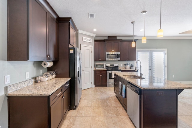 kitchen featuring sink, hanging light fixtures, stainless steel appliances, light stone counters, and ornamental molding