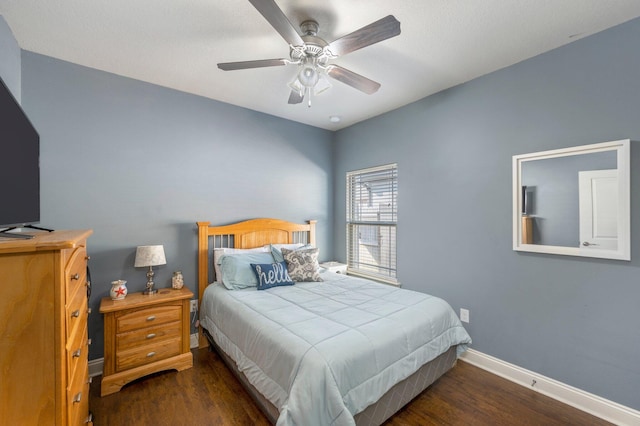 bedroom with dark hardwood / wood-style flooring and ceiling fan