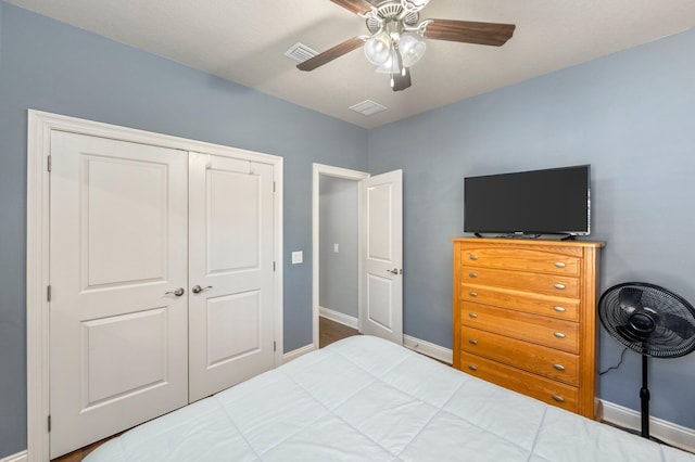 bedroom with ceiling fan and a closet