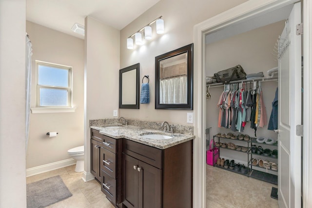 bathroom featuring tile patterned flooring, vanity, and toilet