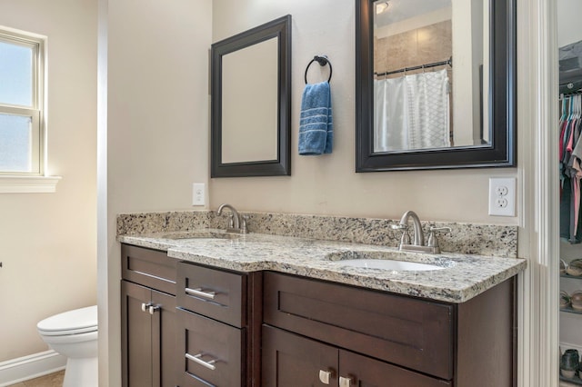 2137 Janet St, Navarre, FL 32566 - bathroom with double vanity, toilet, and a shower with curtain