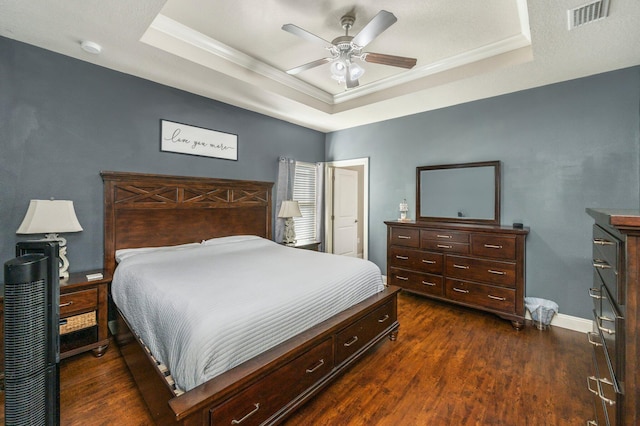 2137 Janet St, Navarre, FL 32566 - bedroom featuring a tray ceiling, ornamental molding, dark wood-type flooring, baseboards, and a ceiling fan