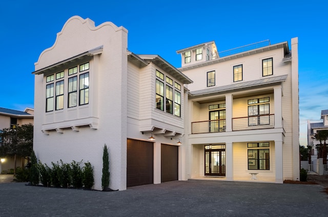 view of front of home featuring a balcony and a garage