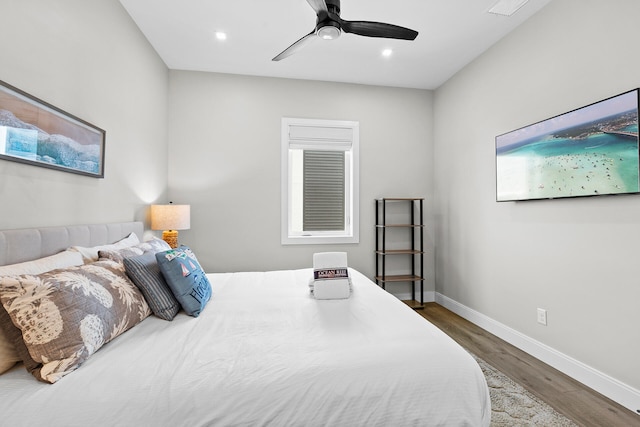 bedroom with ceiling fan and hardwood / wood-style flooring