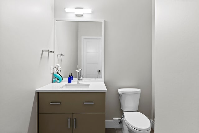 bathroom with vanity, toilet, and tile patterned flooring