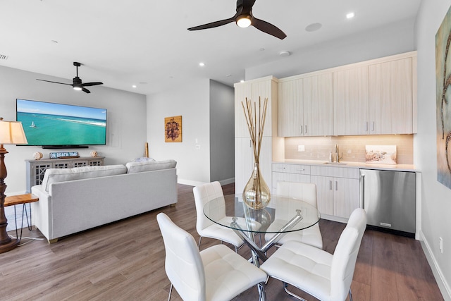 dining room with ceiling fan, hardwood / wood-style flooring, and sink