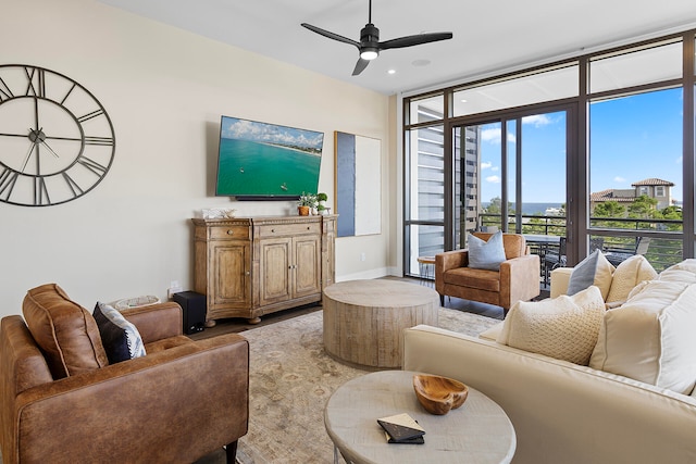 living room featuring ceiling fan and floor to ceiling windows