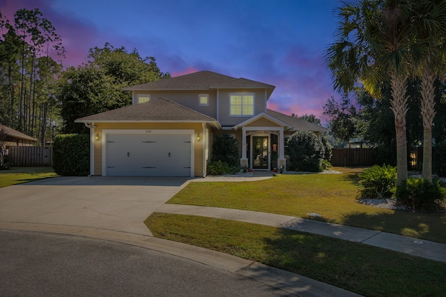 view of front of house with a yard and a garage