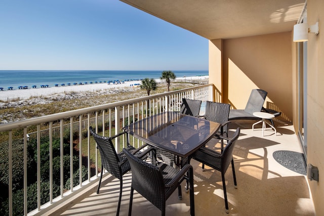 balcony with a water view and a beach view