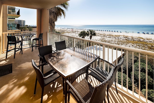 balcony featuring a water view and a beach view