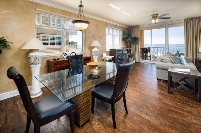 dining area featuring a water view, ceiling fan, dark wood-type flooring, and ornamental molding