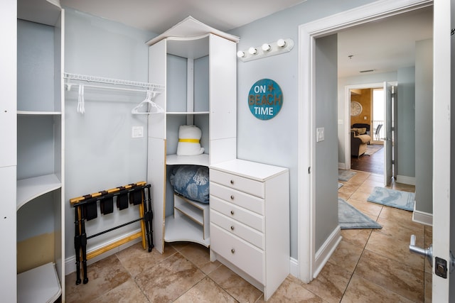 walk in closet featuring light tile patterned floors