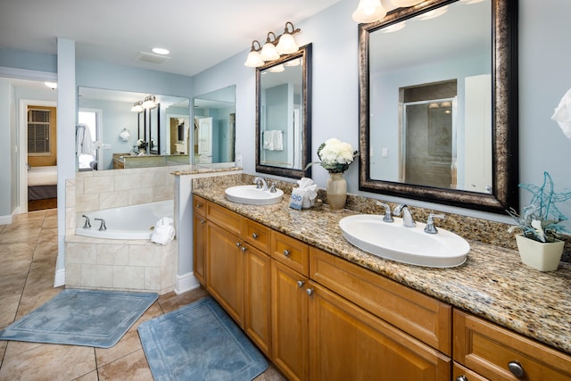 bathroom featuring vanity, shower with separate bathtub, and tile patterned floors