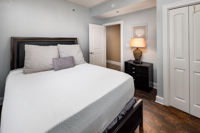 bedroom featuring a closet and dark hardwood / wood-style flooring