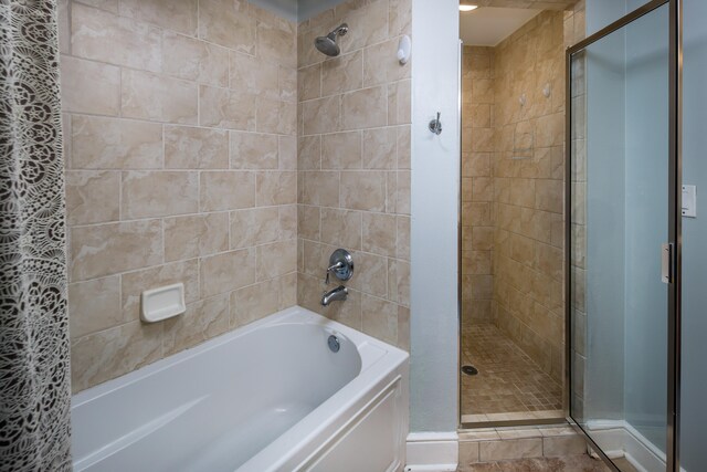 bathroom with tile patterned flooring and separate shower and tub