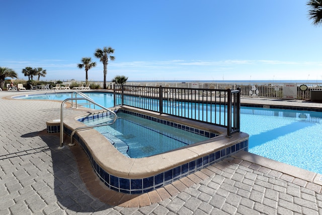 view of pool with a patio and a community hot tub