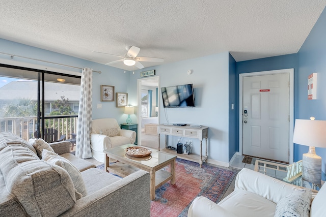 living room featuring a textured ceiling and ceiling fan