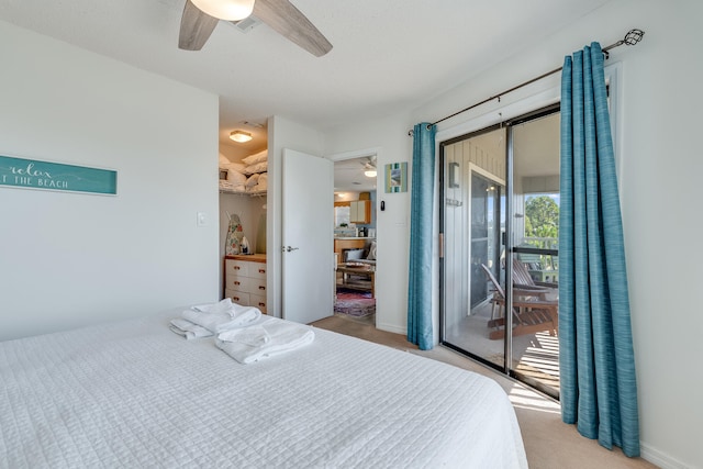 carpeted bedroom featuring a spacious closet, access to exterior, a closet, and ceiling fan