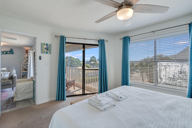 carpeted bedroom featuring a textured ceiling, access to exterior, and ceiling fan