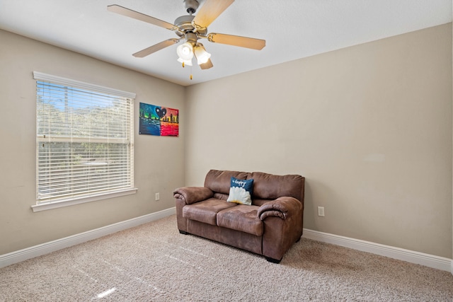 sitting room featuring light carpet and ceiling fan