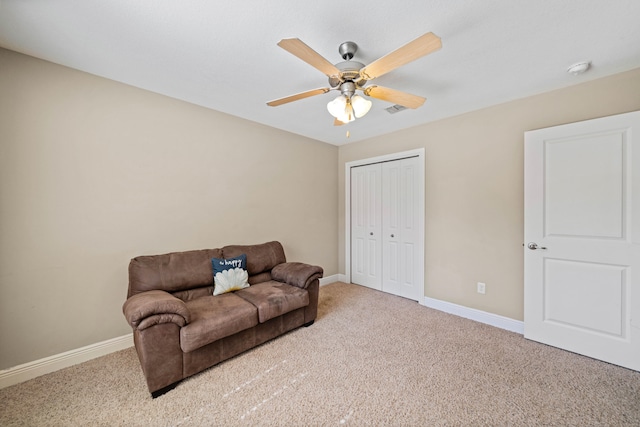 carpeted living room with ceiling fan