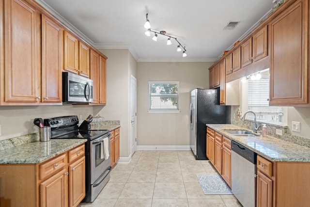 kitchen featuring ornamental molding, sink, light stone counters, and stainless steel appliances