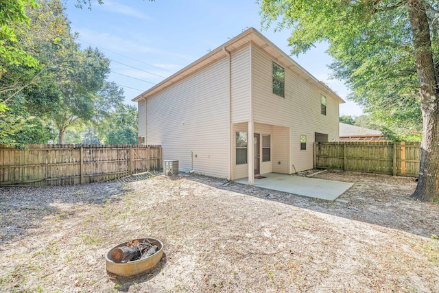 rear view of house featuring a patio and central AC