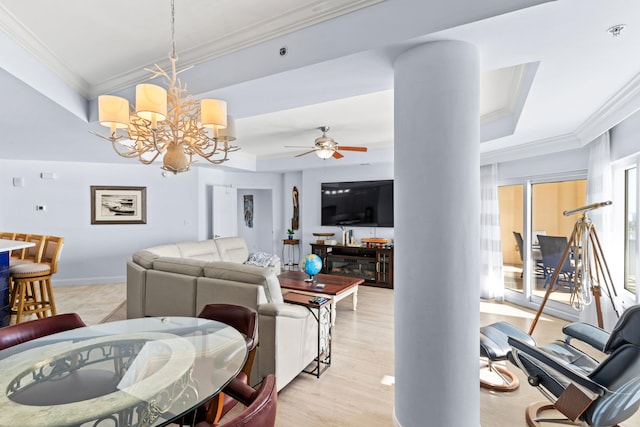 living room featuring crown molding, light wood-type flooring, and ceiling fan with notable chandelier