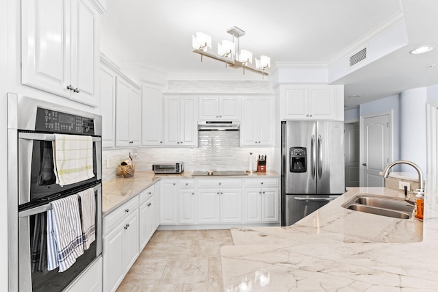 kitchen featuring sink, stainless steel appliances, pendant lighting, white cabinets, and ornamental molding