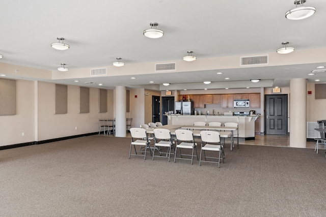 dining space with dark colored carpet