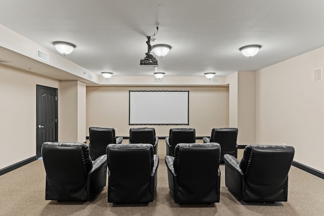 cinema room featuring a textured ceiling and carpet flooring