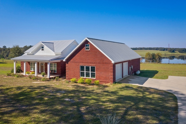 view of front facade featuring a porch, a front lawn, a garage, and a water view