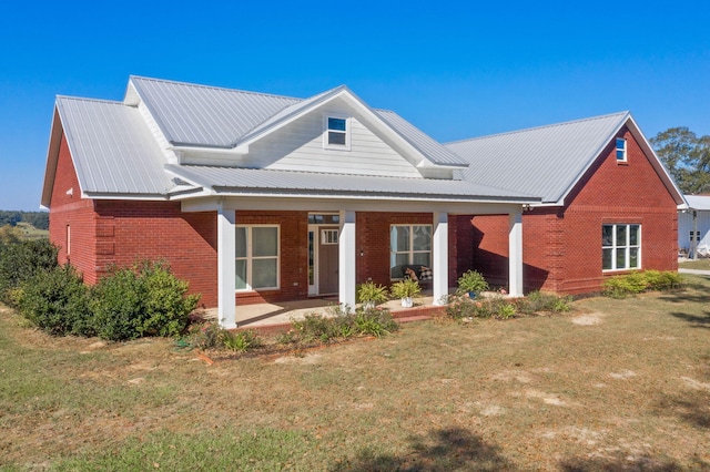 back of house with a yard and covered porch