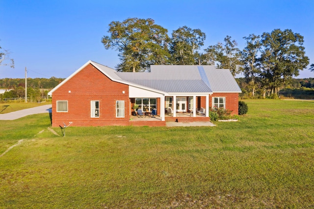 rear view of house with a yard