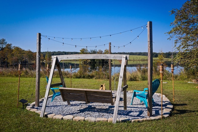 view of playground with a water view and a lawn